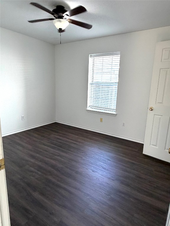 1747 Windy Park Circle Round Rock, TX 78664 - Photo 9 of 12 an empty room with wooden floor chandelier fan and windows