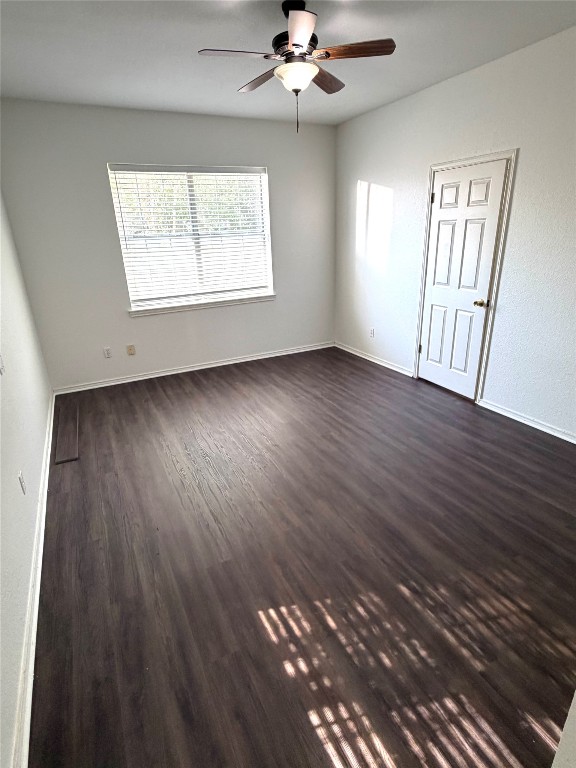 1747 Windy Park Circle Round Rock, TX 78664 - Photo 10 of 12 a view of an empty room with wooden floor and a window