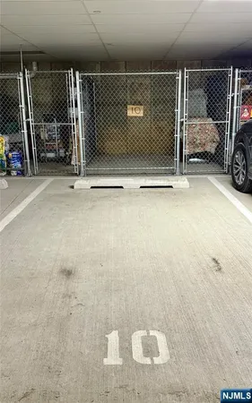 a front view of a house with a garden and lake view