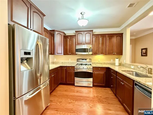 a living room with furniture and a view of kitchen