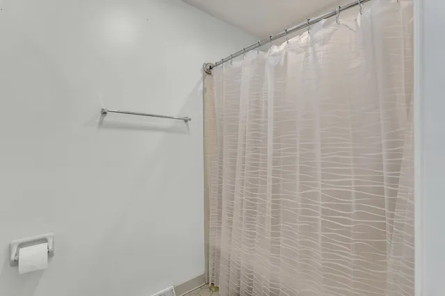 a bathroom with a shower curtain