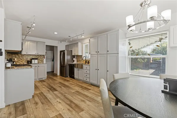 a kitchen with refrigerator cabinets and a sink