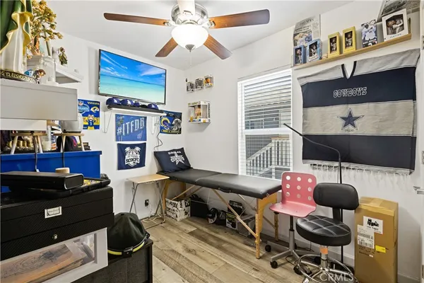 a bedroom with furniture and a flat screen tv