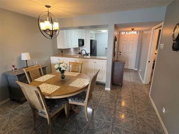 a dining room with furniture and a mirror
