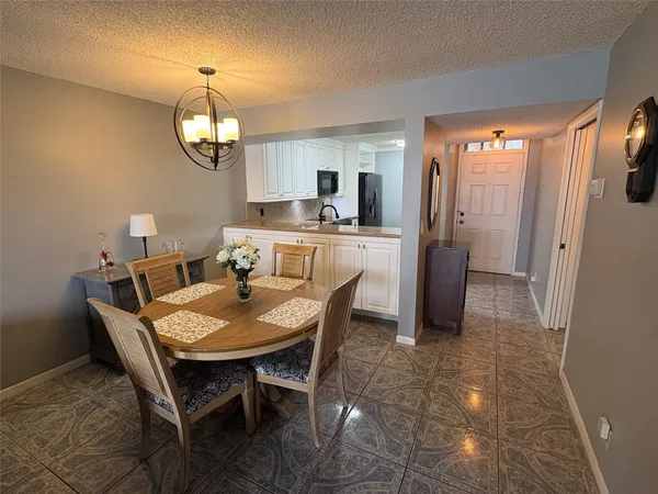 a view of a dining room with furniture wooden floor and chandelier
