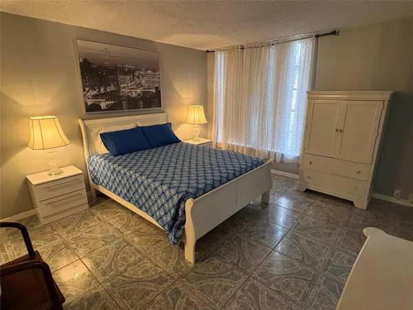 a bedroom with a bed and cabinets