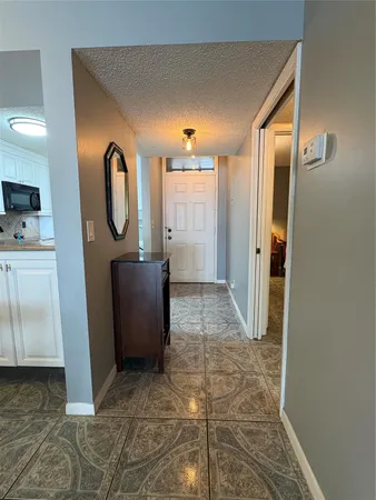 a view of a hallway with washer and dryer