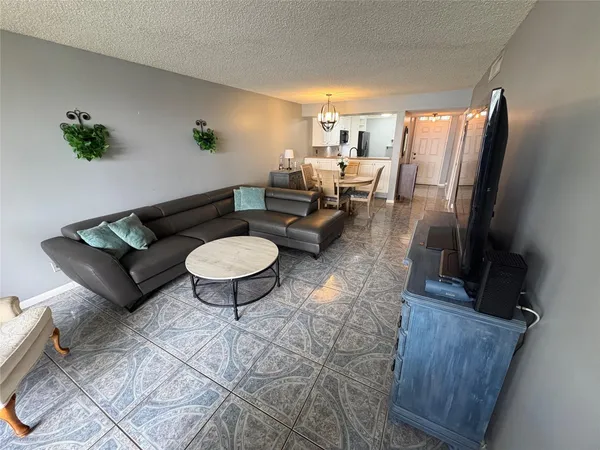 a living room with furniture a rug and a painting