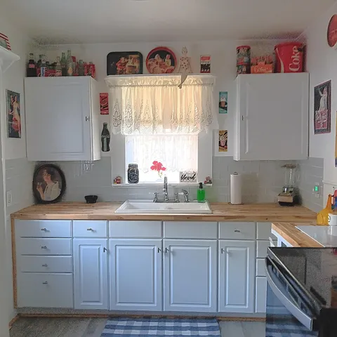 a kitchen with stainless steel appliances a stove a sink and a refrigerator