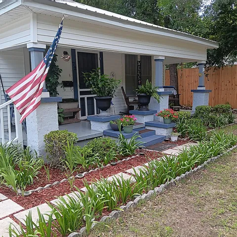 a front view of house with deck and outdoor seating