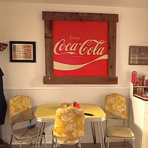 a view of a kitchen with fridge and wooden floor