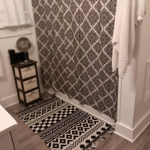 a front view of a house with a yard and green space