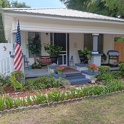 a front view of a house with garden