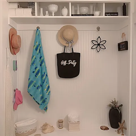 a view of a garden with a bench and trees in the background
