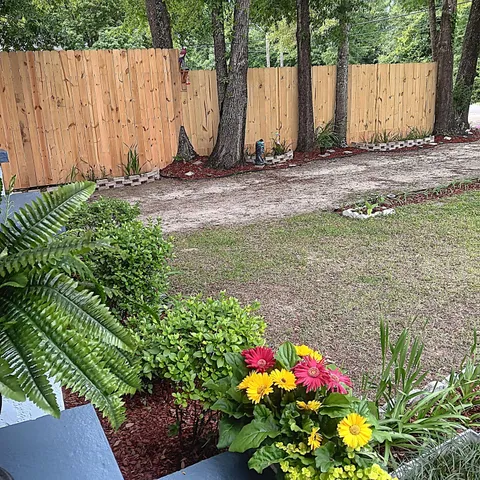 a view of a yard with a trampoline