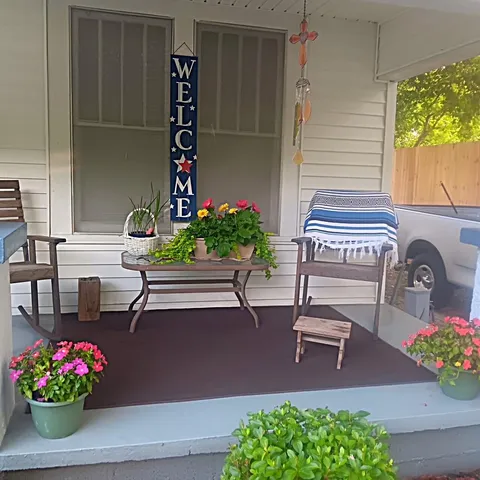 a front view of a house with outdoor seating