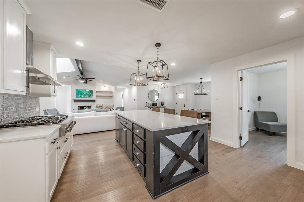 322 Canyon Ridge Drive Richardson, TX 75080 - Photo 11 of 33 a kitchen with stainless steel appliances granite countertop a stove a sink dishwasher and a refrigerator