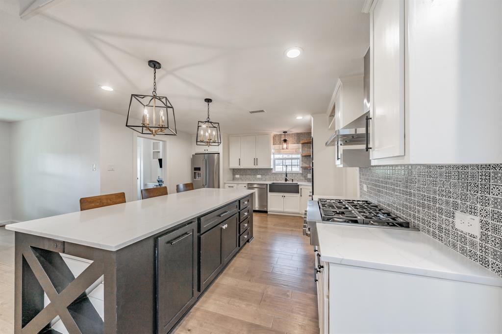 322 Canyon Ridge Drive Richardson, TX 75080 - Photo 12 of 33 a kitchen with a counter space a sink stainless steel appliances and cabinets