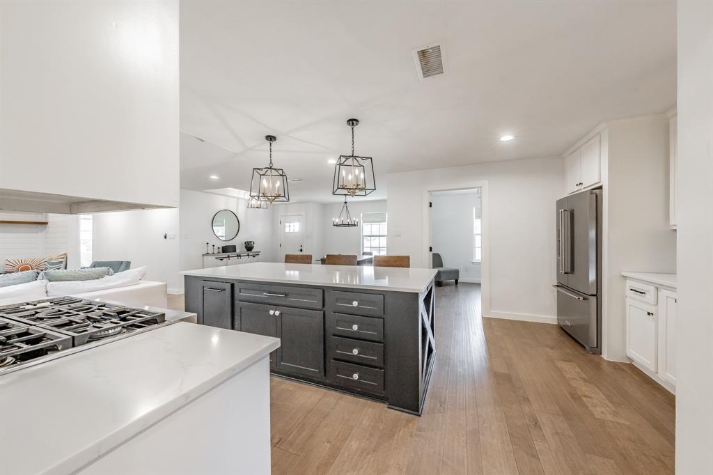 322 Canyon Ridge Drive Richardson, TX 75080 - Photo 15 of 33 a kitchen with a sink a stove and refrigerator