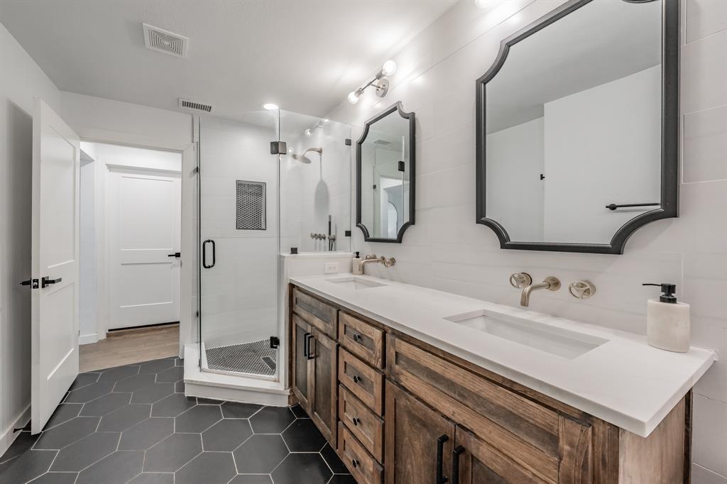 322 Canyon Ridge Drive Richardson, TX 75080 - Photo 19 of 33 a spacious bathroom with double vanity sink a mirror and a shower
