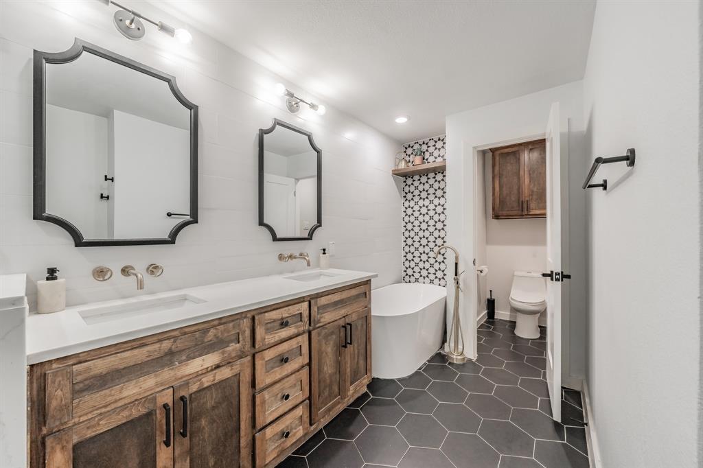 322 Canyon Ridge Drive Richardson, TX 75080 - Photo 20 of 33 a spacious bathroom with a double vanity sink mirror and toilet