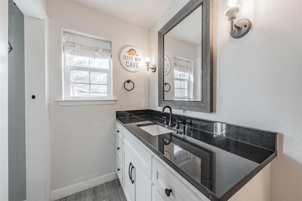 322 Canyon Ridge Drive Richardson, TX 75080 - Photo 26 of 33 a bathroom with a sink and a mirror