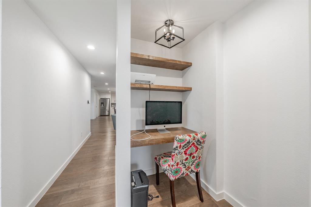 322 Canyon Ridge Drive Richardson, TX 75080 - Photo 28 of 33 a hallway with a stove and a microwave oven