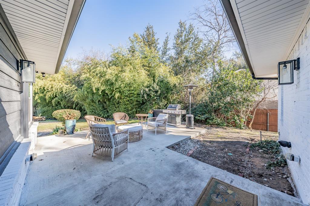 322 Canyon Ridge Drive Richardson, TX 75080 - Photo 30 of 33 a view of a patio with table and chairs and potted plants
