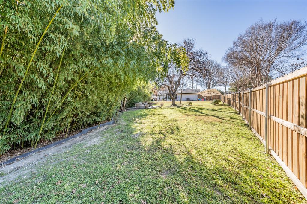 322 Canyon Ridge Drive Richardson, TX 75080 - Photo 33 of 33 a view of yard with swimming pool and trees in the background