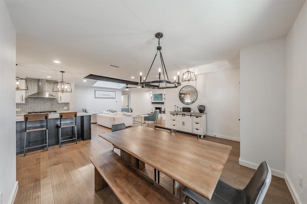 322 Canyon Ridge Drive Richardson, TX 75080 - Photo 5 of 33 a kitchen with stainless steel appliances a stove a sink a oven a dining table and chairs