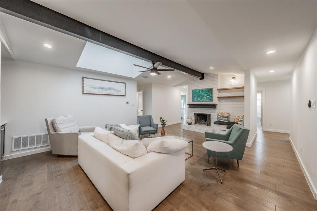 322 Canyon Ridge Drive Richardson, TX 75080 - Photo 7 of 33 a living room with furniture and a fireplace