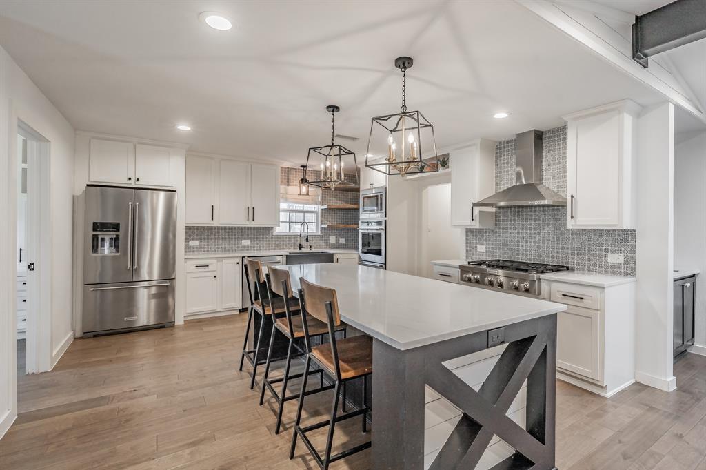 322 Canyon Ridge Drive Richardson, TX 75080 - Photo 10 of 33 a kitchen with stainless steel appliances granite countertop a stove a refrigerator a oven a sink a table and chairs