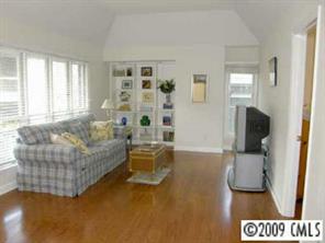 607 Queens Road, Unit E Charlotte, NC 28207 - Photo 2 of 8 a living room with furniture and a flat screen tv