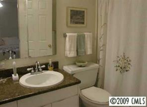 607 Queens Road, Unit E Charlotte, NC 28207 - Photo 6 of 8 a bathroom with a sink a toilet and a mirror