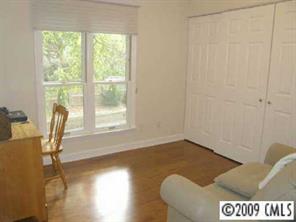 607 Queens Road, Unit E Charlotte, NC 28207 - Photo 7 of 8 a view of a livingroom with wooden floor and a window