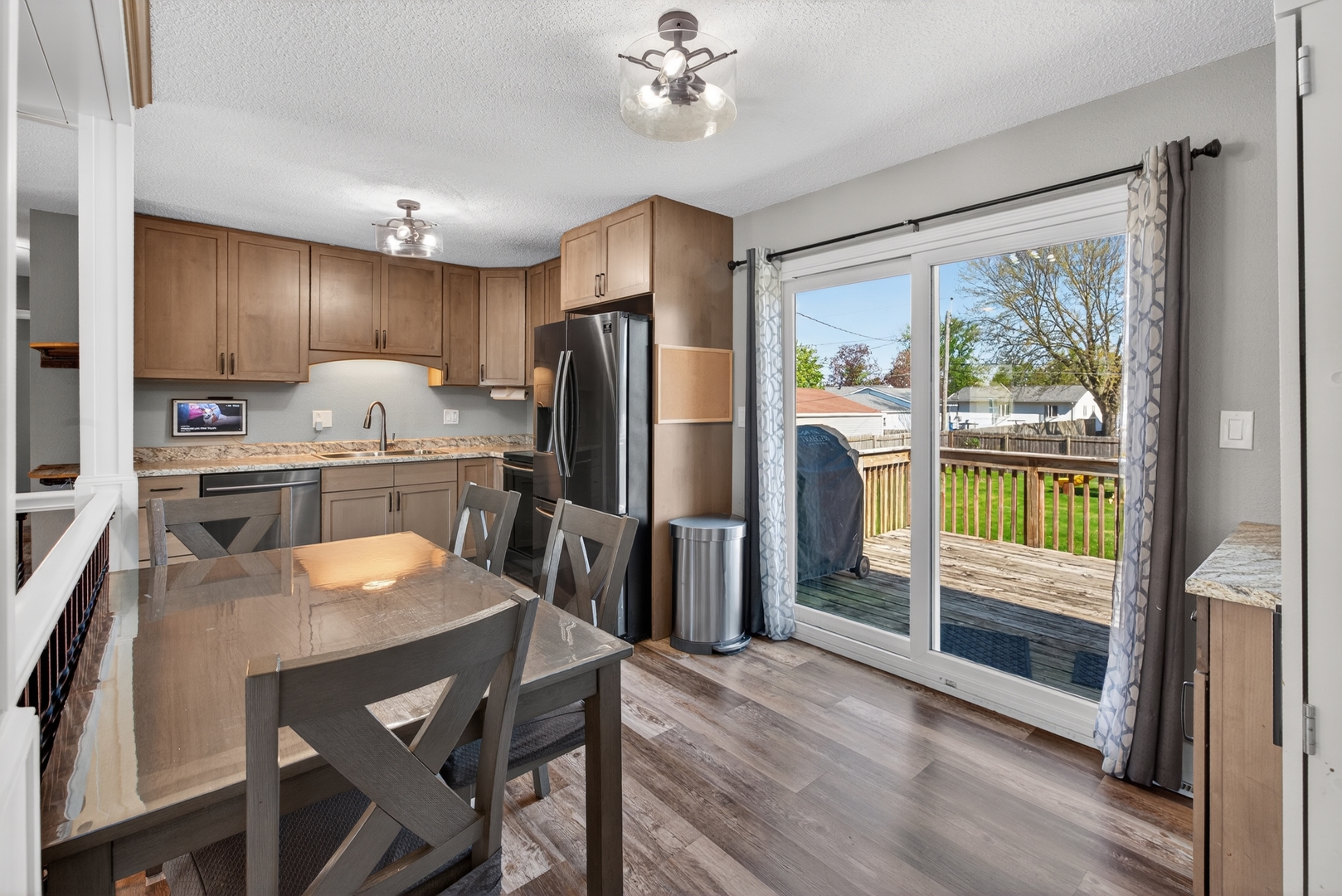 602 14th Place Camanche, IA 52730 - Photo 13 of 23 a kitchen with a table chairs refrigerator and microwave