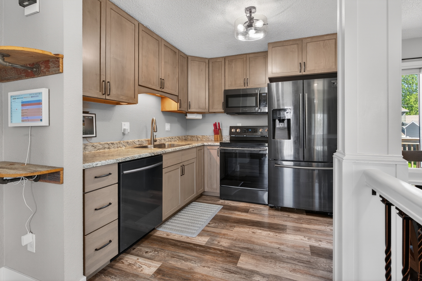 602 14th Place Camanche, IA 52730 - Photo 14 of 23 a kitchen with a refrigerator sink and wooden cabinets