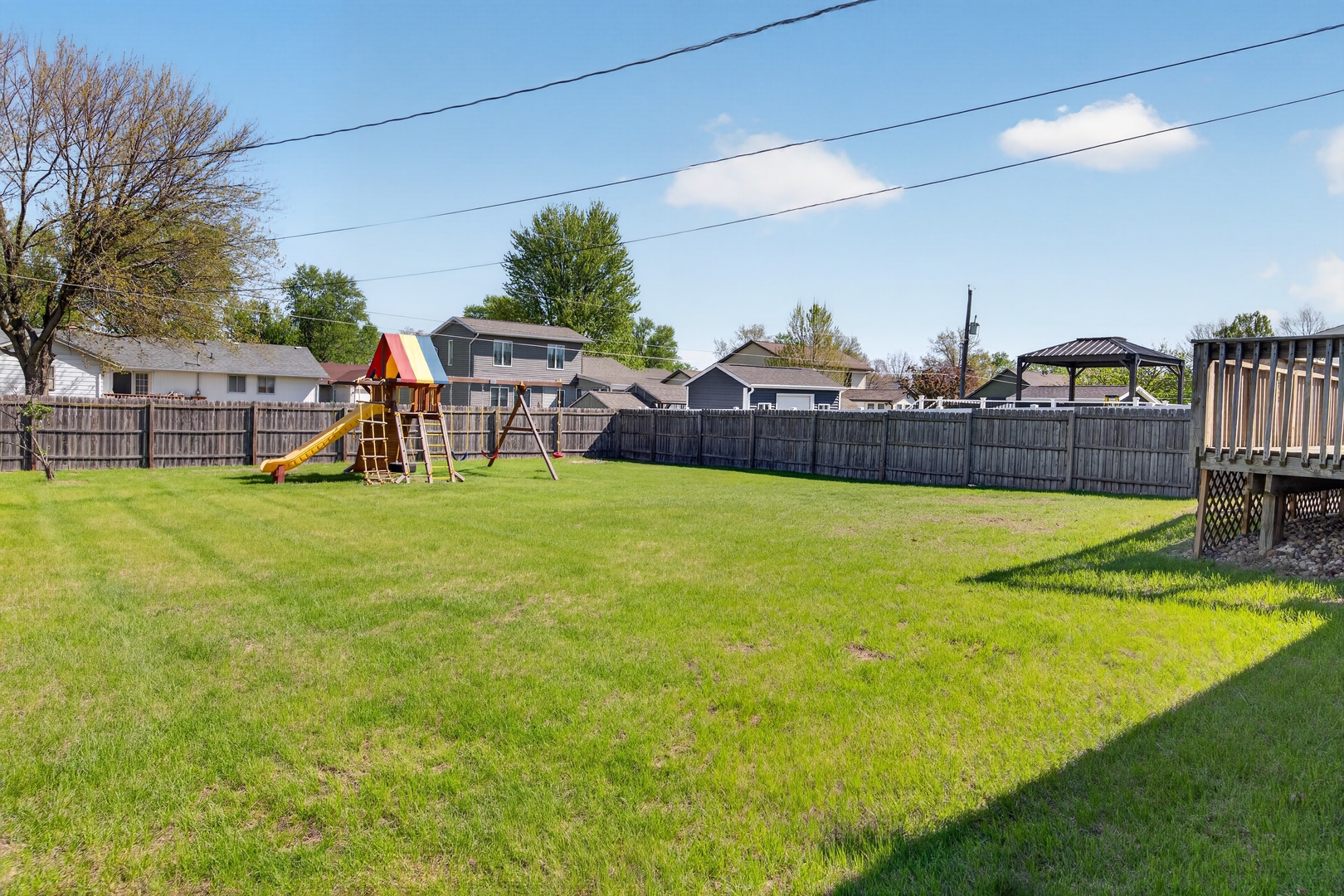 602 14th Place Camanche, IA 52730 - Photo 4 of 23 a view of a swimming pool with a chair and a big yard