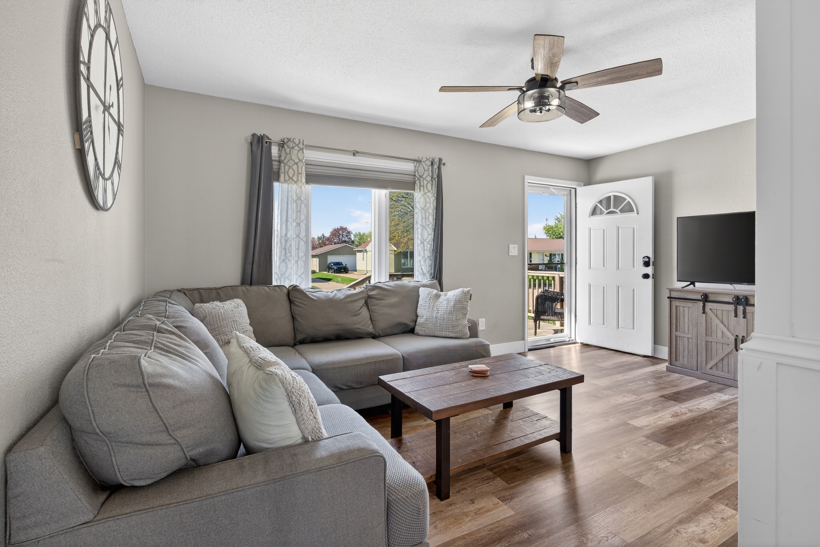 602 14th Place Camanche, IA 52730 - Photo 8 of 23 a living room with furniture a flat screen tv and a table