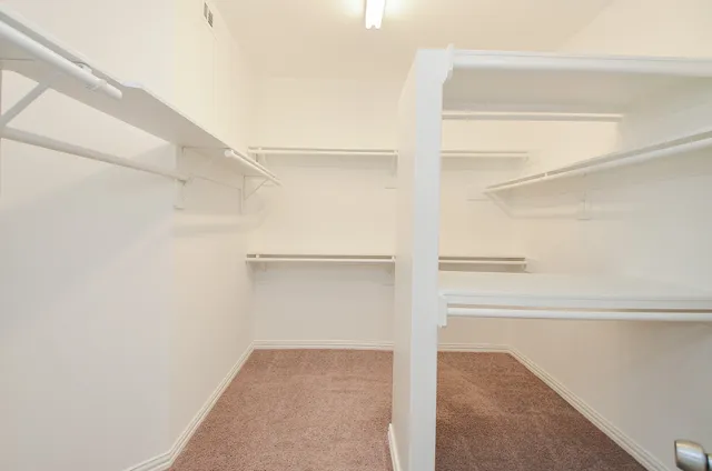a spacious bathroom with a double vanity sink mirror and bathtub
