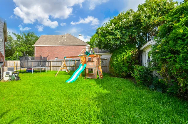 a backyard of a house with table and chairs