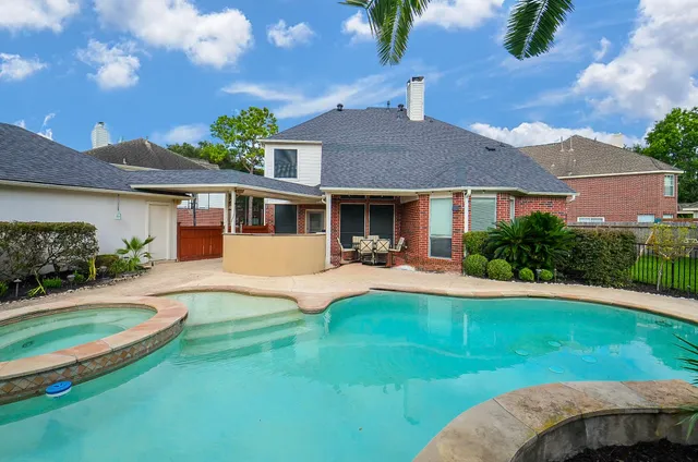 a view of a swimming pool with a garden