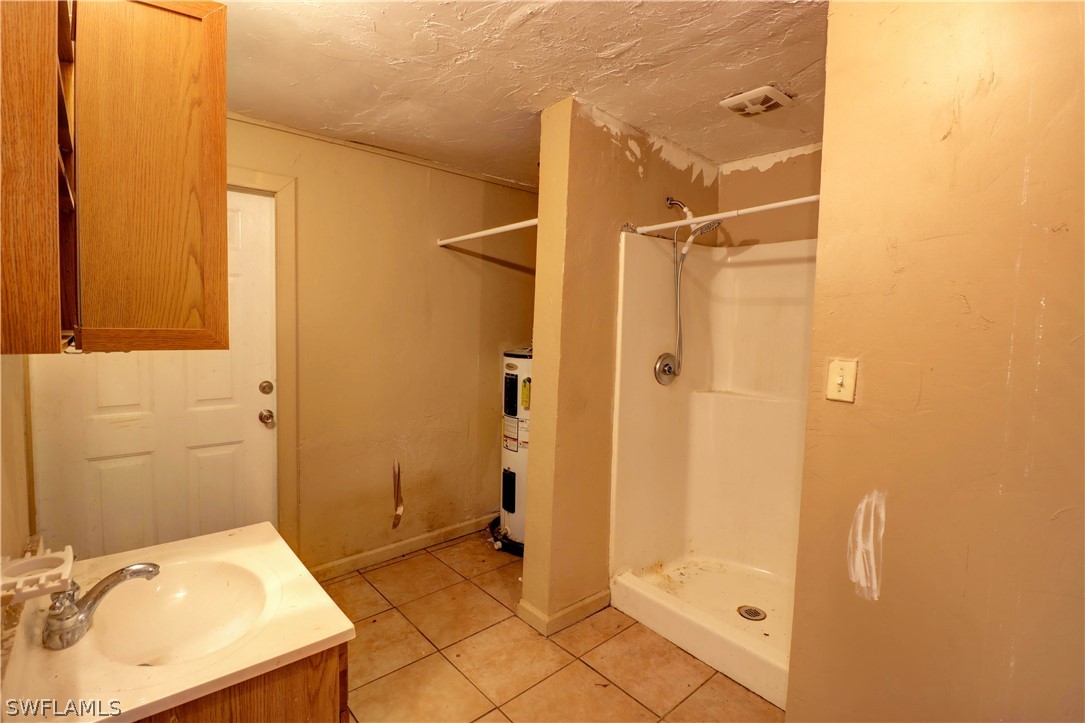 121 Texas Road Lehigh Acres, FL 33936 - Photo 17 of 18 a bathroom with a sink and shower