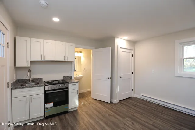 a kitchen with wooden floor and steel stainless steel appliances