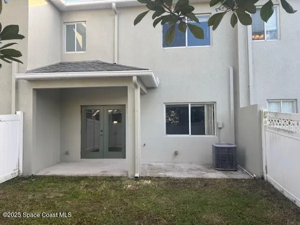 a view of house with backyard