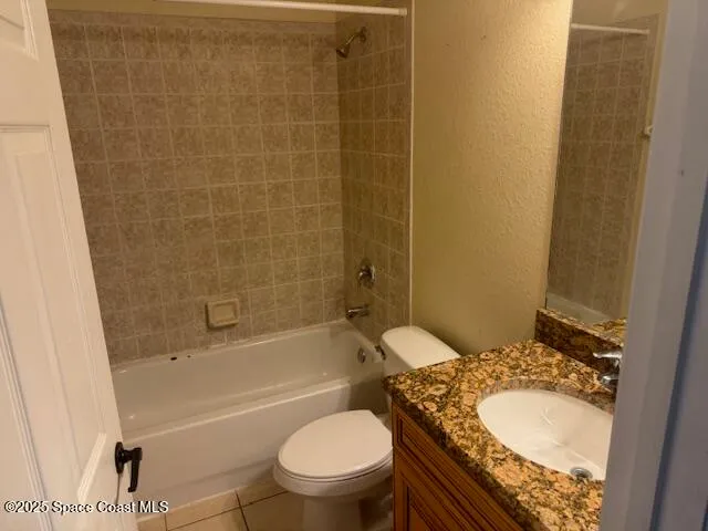 a bathroom with a granite countertop toilet sink and shower