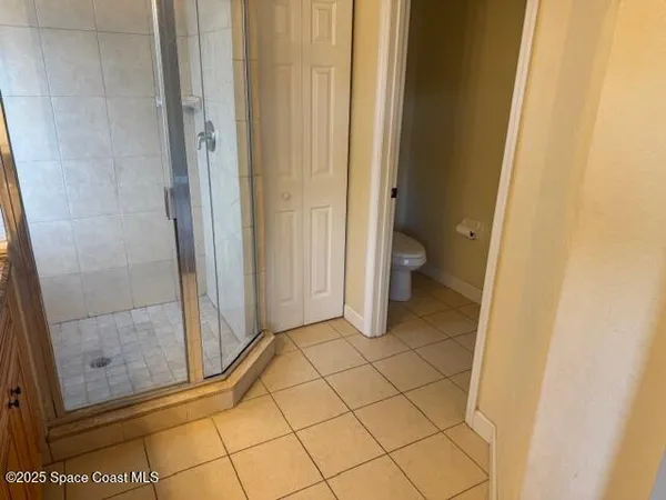 a bathroom with a granite countertop shower and a sink