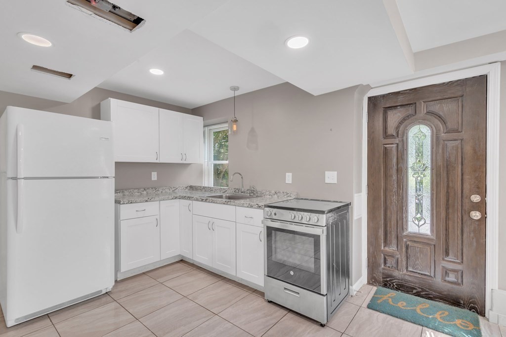 a kitchen with a sink stove and refrigerator