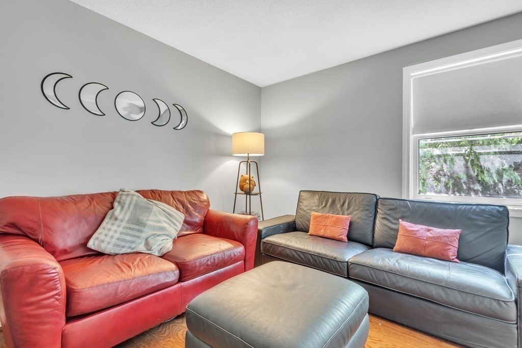 1638 Parker Street Springfield, MA 01128 - Photo 16 of 36 a blue couch sitting next to a window