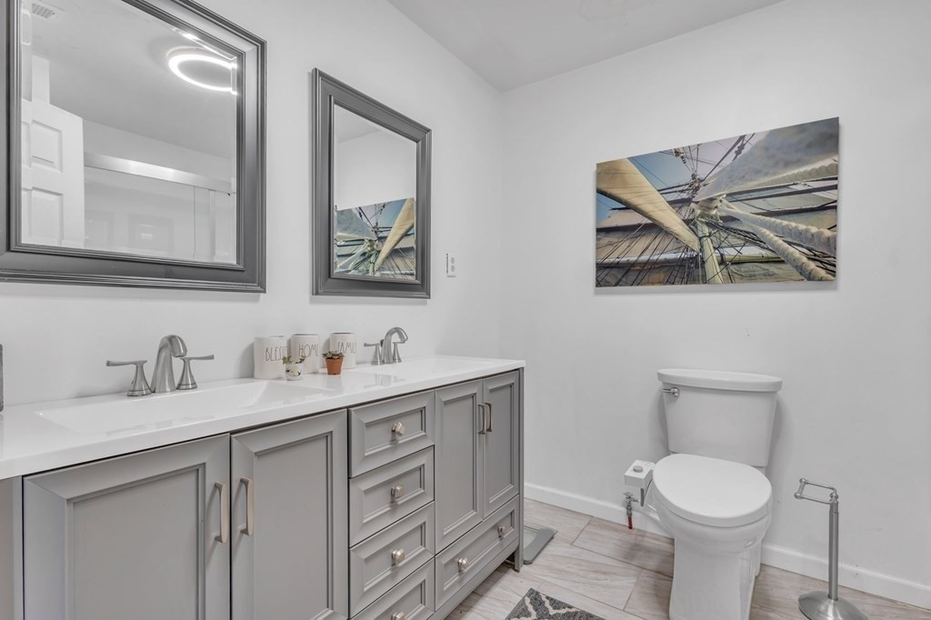 1638 Parker Street Springfield, MA 01128 - Photo 17 of 36 a bathroom with a toilet a sink and mirror